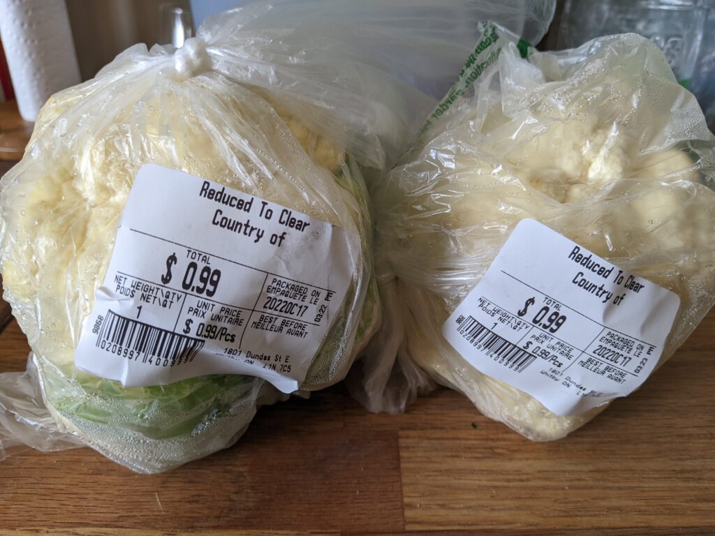 Two whole cauliflower heads for $0.99 each. Save on groceries by checking the discount rack in the produce department.