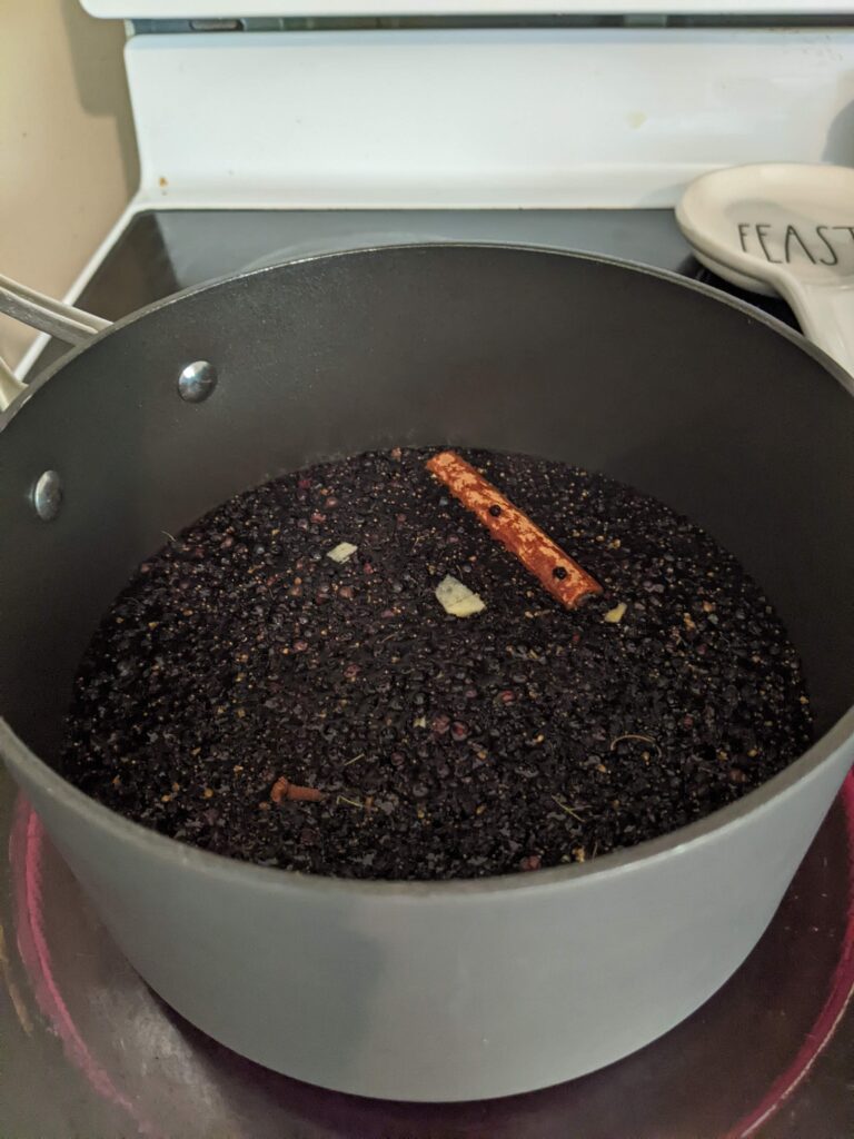 Making Elderberry syrup in a Tupperware saucepan