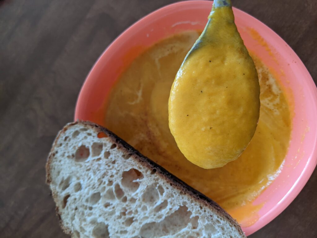 carrot soup with a slice of bread
