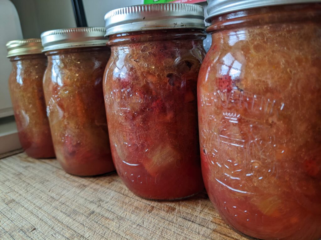 Jars of home canned strawberry rhubarb pie filling