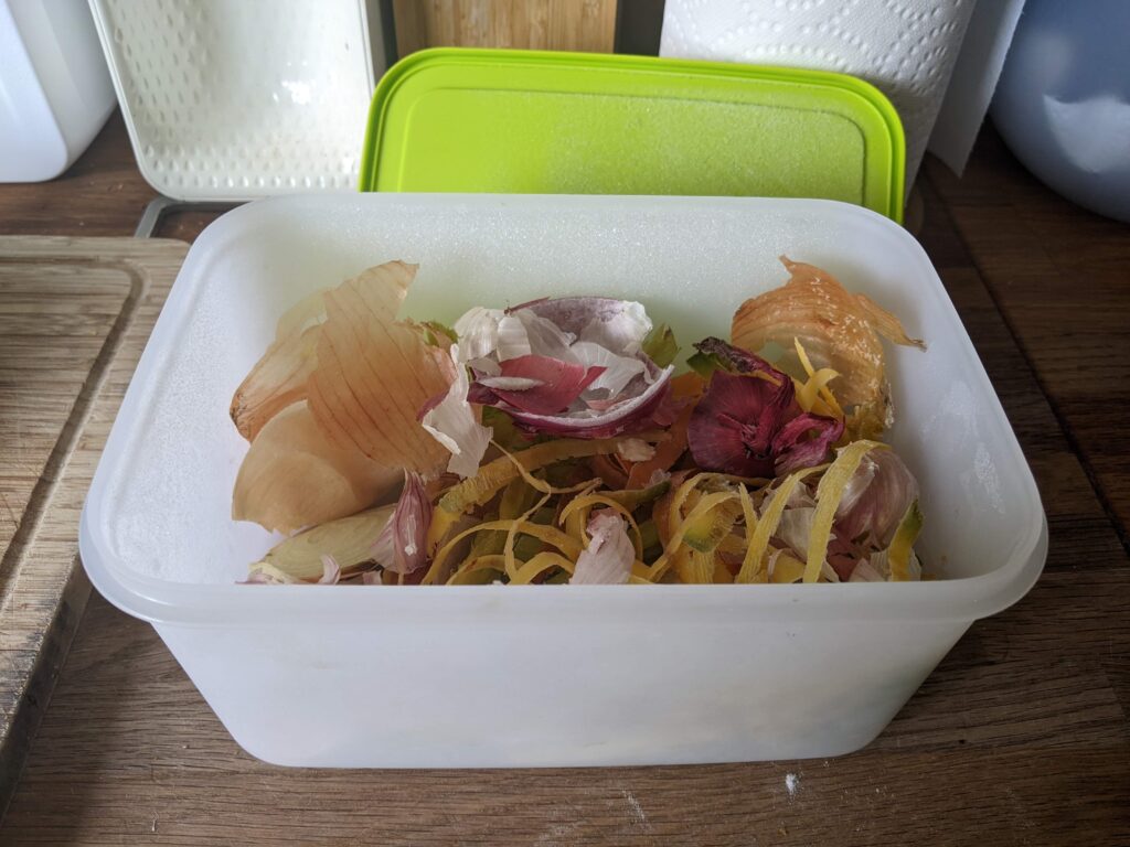 Tupperware Freezer Mate container filled with vegetable scraps