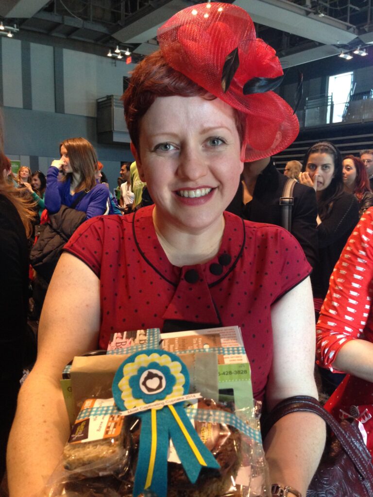 Heather holding her prize for most captivating cupcake.