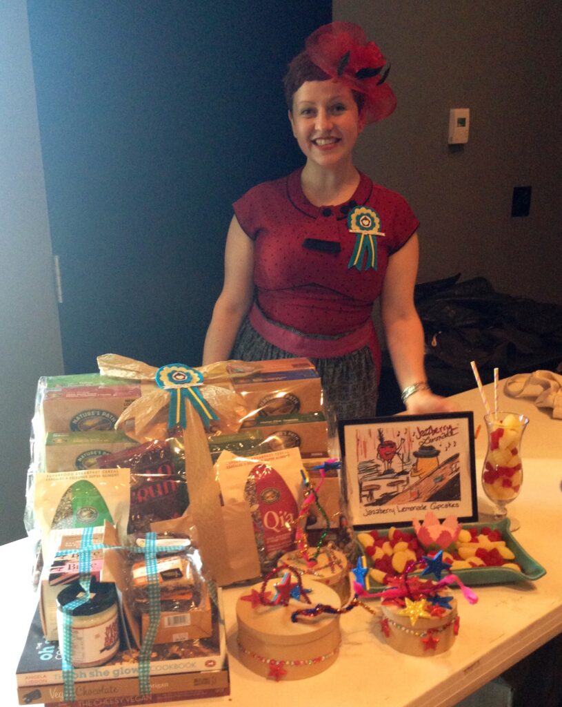 Heather standing behind the prizes won for best in show and most captivating cupcake.