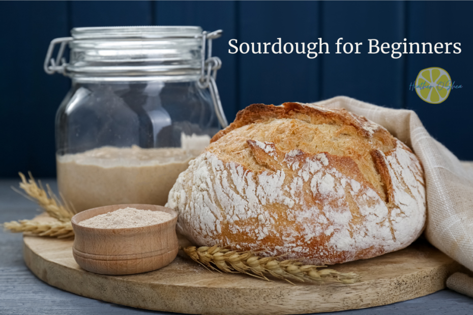 A rustic loaf of sourdough bread with a golden, crispy crust sits on a wooden cutting board, lightly dusted with flour. Beside it, a small wooden bowl holds whole grain flour, and a jar of sourdough starter with a metal clasp lid is placed in the background. A beige linen cloth is draped over part of the bread. The text 'Sourdough for Beginners' is displayed in the upper right corner against a dark blue background, accompanied by a small logo with a green lime slice and the words "Heather O'Shea".